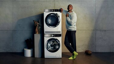 Man standing beside washing machine