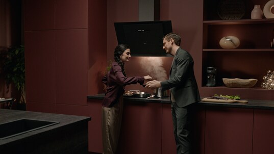 Man and woman talking in kitchen